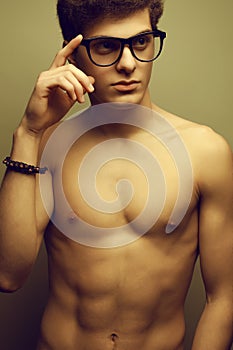 Handsome muscular male model with nice body wearing eyewear