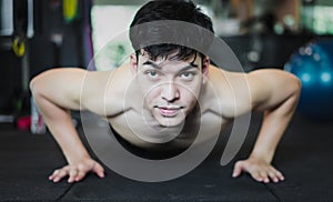 Handsome muscular man doing push-ups. Muscular and strong guy ex