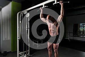 Handsome Muscular Man Flexing Muscles In Gym