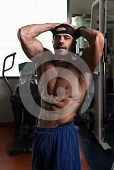 Handsome Muscular Man Flexing Muscles In Gym