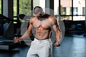 Handsome Muscular Man Flexing Muscles In Gym