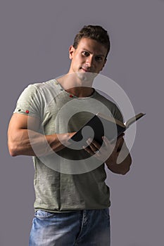 Handsome Muscular Man Reading Book