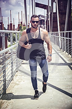 Handsome muscular man standing outdoor in city