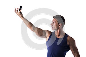 Handsome muscular young man taking selfie with