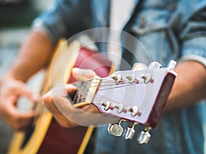 handsome musician playing acoustic guitar on blur background. World music day. music and instrument concept.