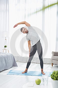 Handsome nice man doing gymnastics