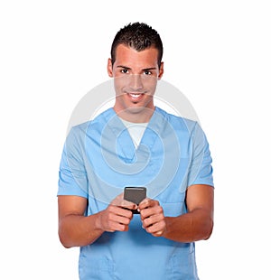 Handsome nurse man texting with his cellphone