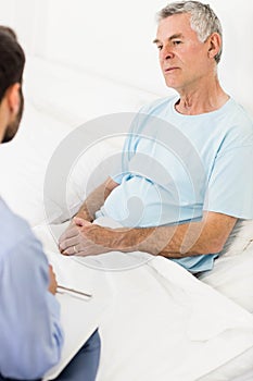 Handsome nurse visiting a mature man