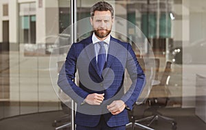 Handsome office worker. Coffee break near the business center. Business man standing on the city street near business