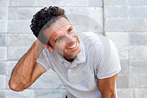 Handsome older man laughing with hand in hair