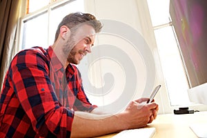 Handsome older man sitting and using cellphone