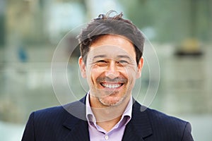 Handsome older man in suit with big smile on his face