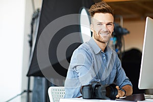 Handsome Photographer using Computer