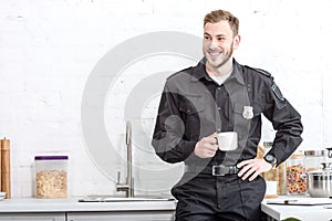 Handsome police officer drinking coffee