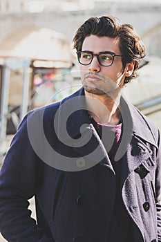 Handsome portrait man with glasses outdoor. Model hair and clothing style.