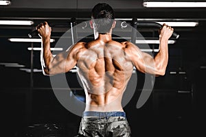 Handsome power athletic man diet training pumping up back muscle