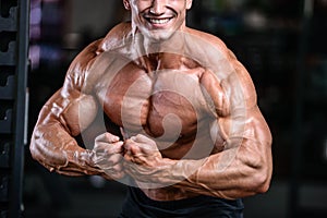 Handsome power athletic man on diet training pumping up muscles