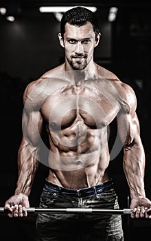 Handsome power athletic man on diet training pumping up muscles