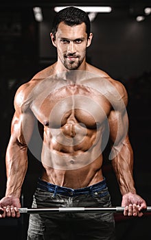 Handsome power athletic man on diet training pumping up muscles