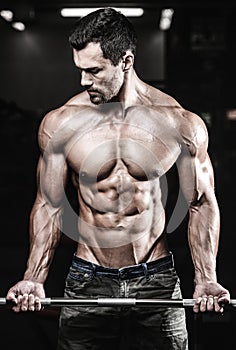 Handsome power athletic man on diet training pumping up muscles