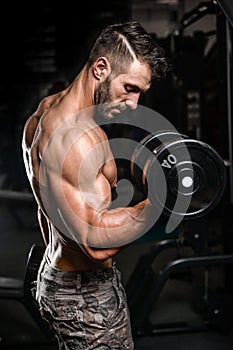 Handsome power athletic man on diet training pumping up muscles