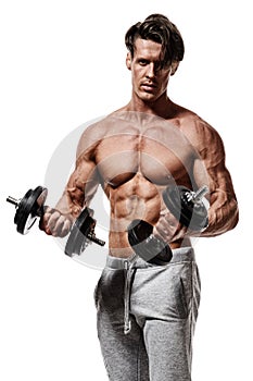 Handsome power athletic man in training pumping up muscles with