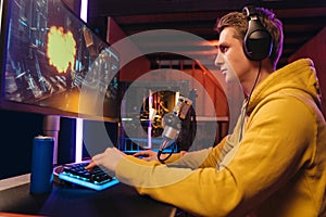 Handsome pro cyber sportsman streaming live video from esport tournament