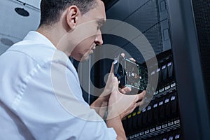 Handsome professional technician working with communication server