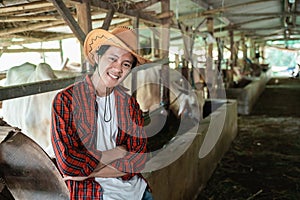 handsome rancher wearing a cowboy hat with crossed hands pose