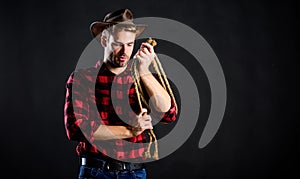 Handsome rancher. western cowboy portrait. wild west rodeo. man in hat black background. cowboy with lasso rope. Western