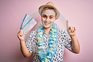 Handsome redhead tourist man on vacation wearing hawaiian lei holding boarding pass airlane surprised with an idea or question