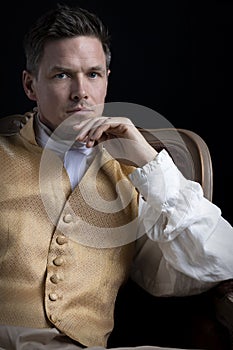 A handsome Regency gentleman wearing a gold waistcoat