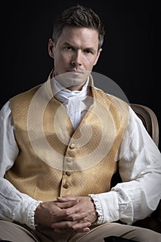 A handsome Regency gentleman wearing a gold waistcoat