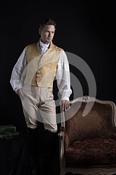 A handsome Regency gentleman wearing a gold waistcoat