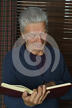 Handsome retired man reading book