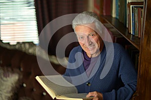 Handsome retired man reading book