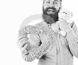 Handsome romantic guy is smiling while making present