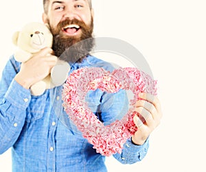 Handsome romantic guy is smiling while making present