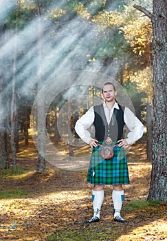 Handsome scottish man in the forest