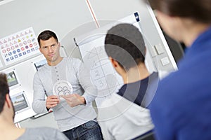 Handsome senior driving instructor in class