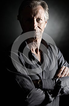 Handsome Senior Man against Dark Background