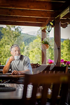 Handsome senior man enjoying his morning coffee