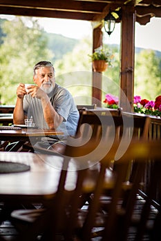 Handsome senior man enjoying his morning coffee