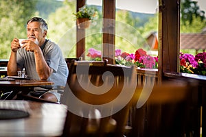 Handsome senior man enjoying his morning coffee