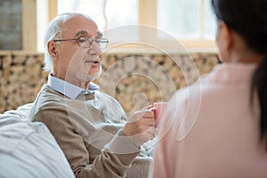 Handsome senior man enjoying tea