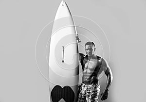 Handsome serfer man with serf board. Male fit with athletic body. Surfboard man with serf board. Surfer with a surfboard