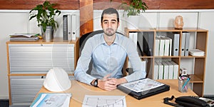 Handsome serious man sit at office boss manager desk