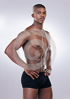 Handsome, shirtless and portrait of a man in a studio with a muscular body in underwear. Serious, fitness and young