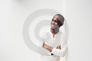 Handsome smiling African American man with arms crossed against white background