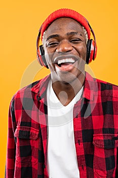 Handsome smiling black american man listening to music using headphones